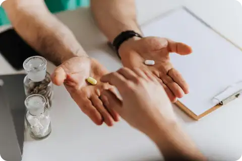 A healthcare professional presenting two probiotic supplements to a patient